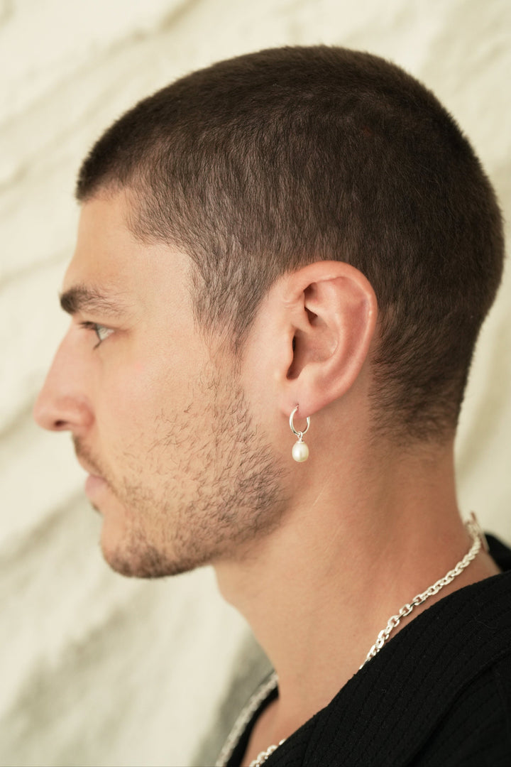 Founder of Nusands Corey Micari side profile wearing Sterling Silver hoop earring with removable pearl charm