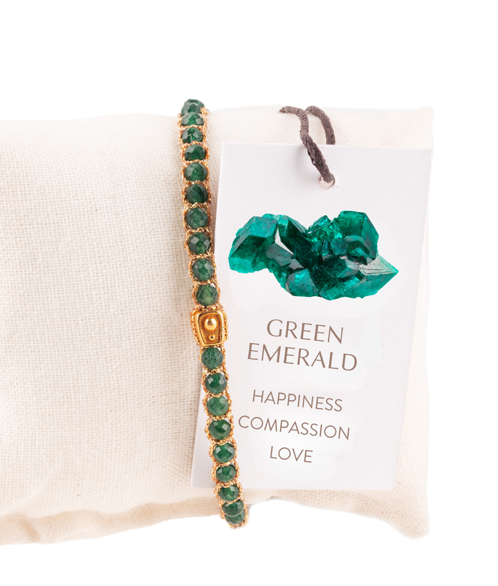 Green emerald bracelet on a card with text and green crystal