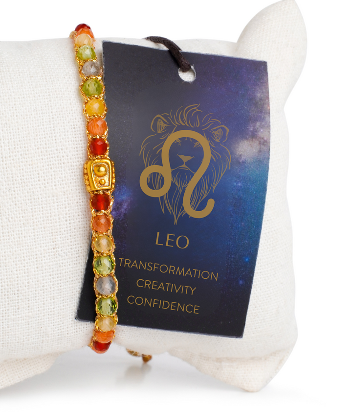 Colorful beaded bracelet with a Leo zodiac card on a white surface