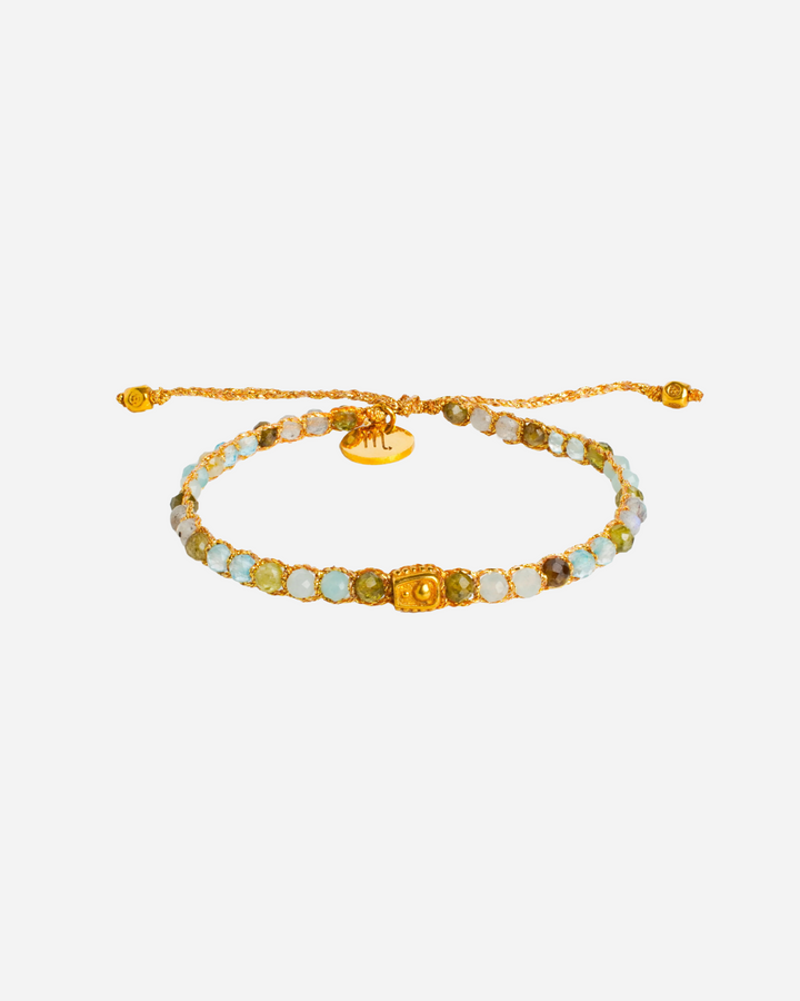 Scorpio Crystal Zodiac Gemstone Bracelet with different blue, purple, and clear gemstones woven in pure silver yarn and plated with 18k gold.