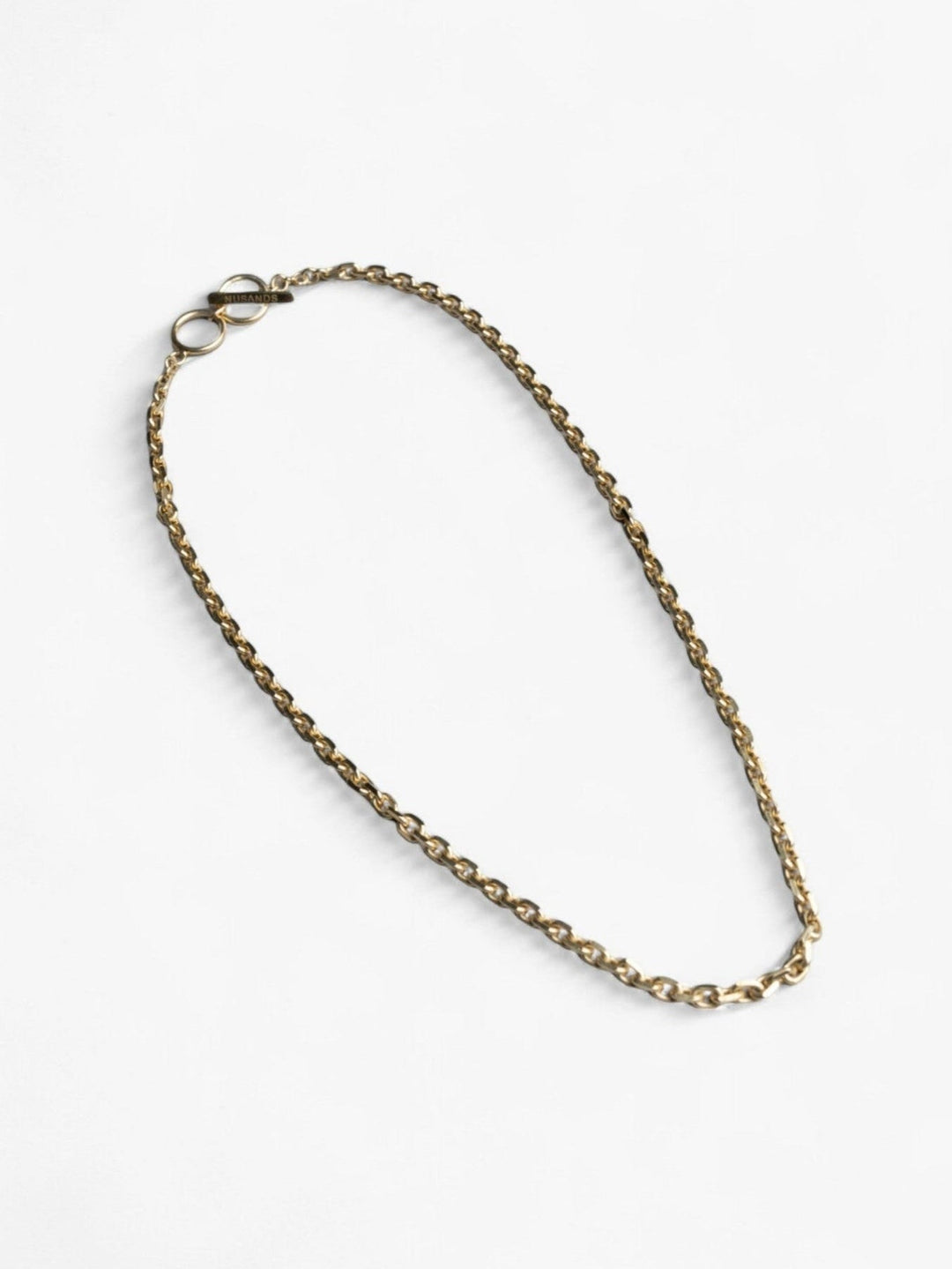 Chunky 18K Gold Shackled Necklace with link chain and clasp laying flat