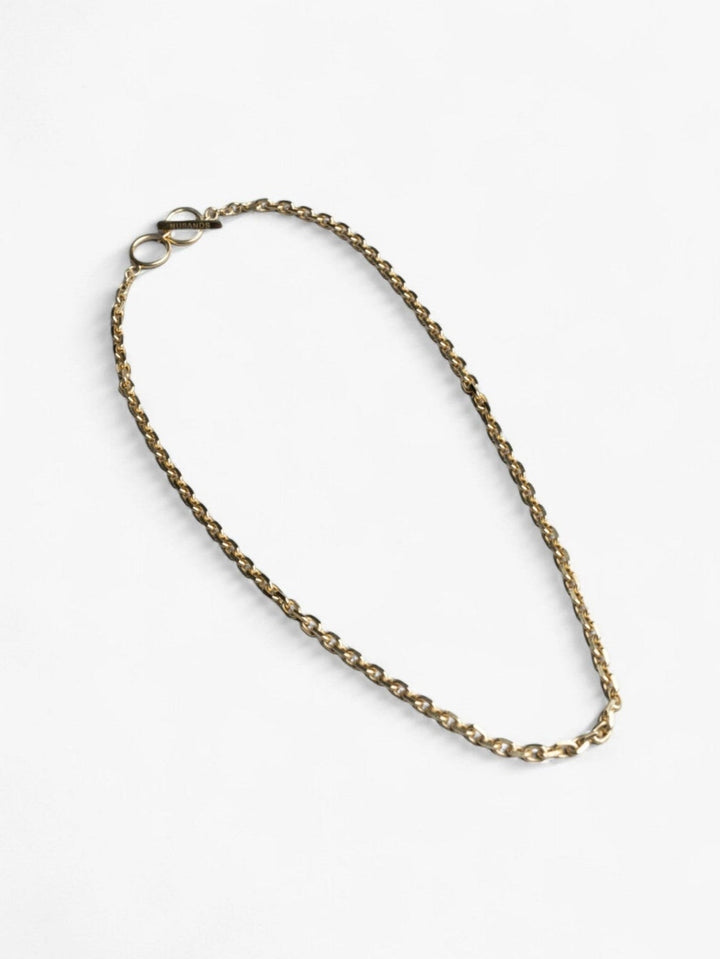 Chunky 18K Gold Shackled Necklace with link chain and clasp laying flat