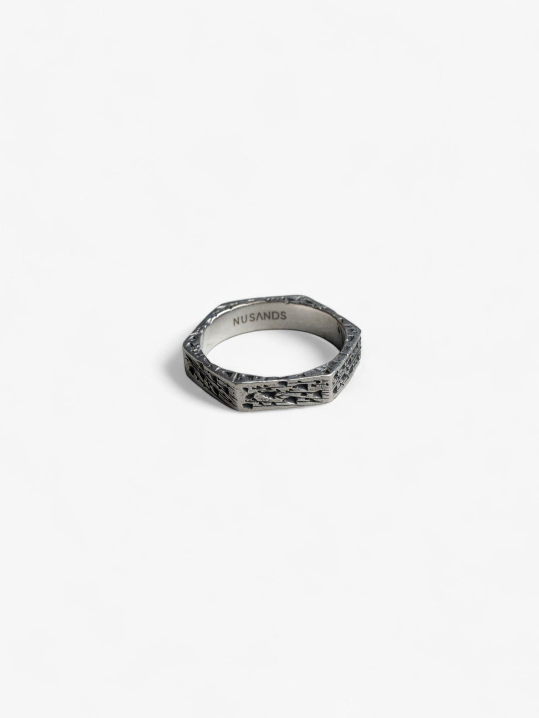 hexagon shaped sterling silver ring laying flat, hammered oxidised finish - nusands six base ring.