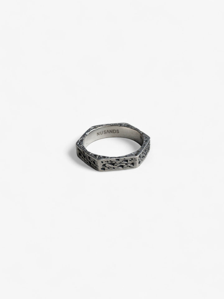 hexagon shaped sterling silver ring laying flat, hammered oxidised finish - nusands six base ring.