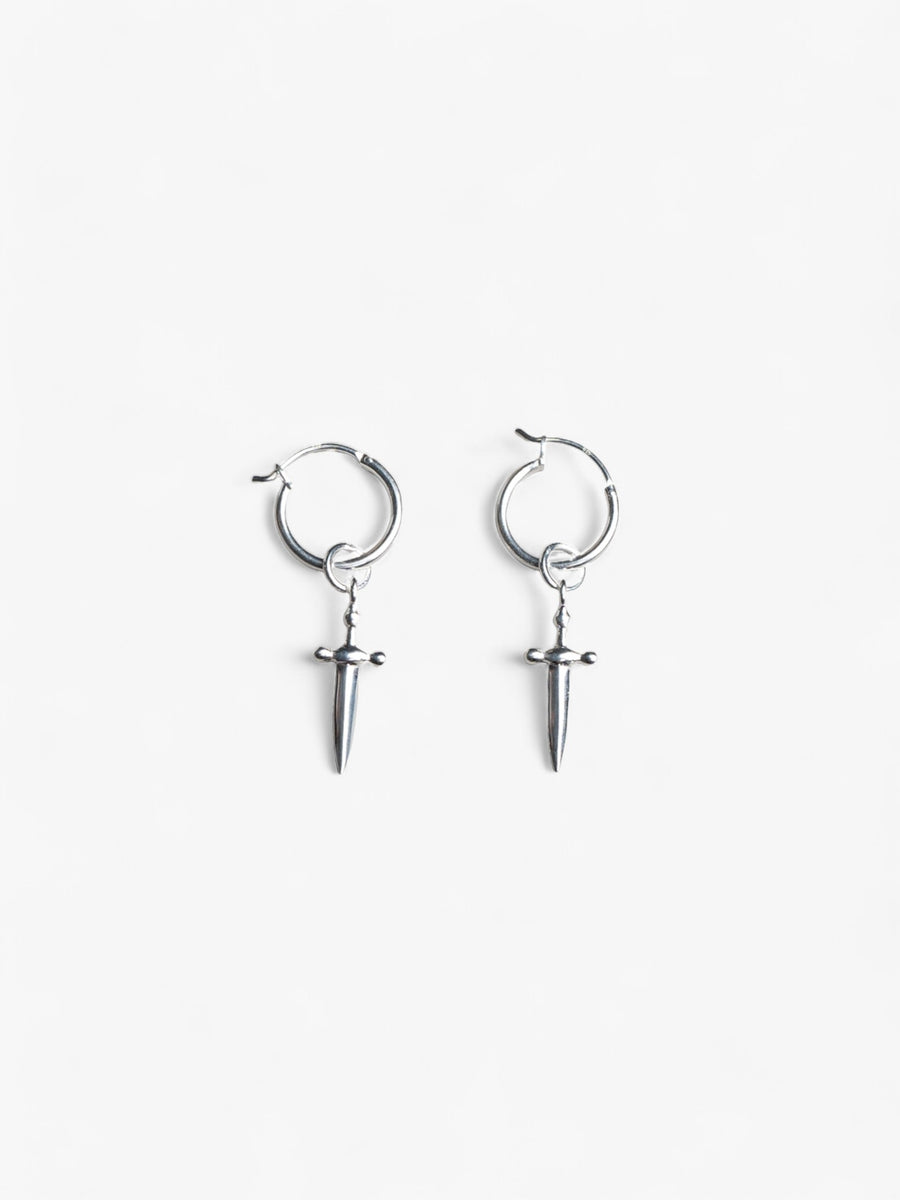 pair of sterling silver hoop earrings with removable sword charms laying flat