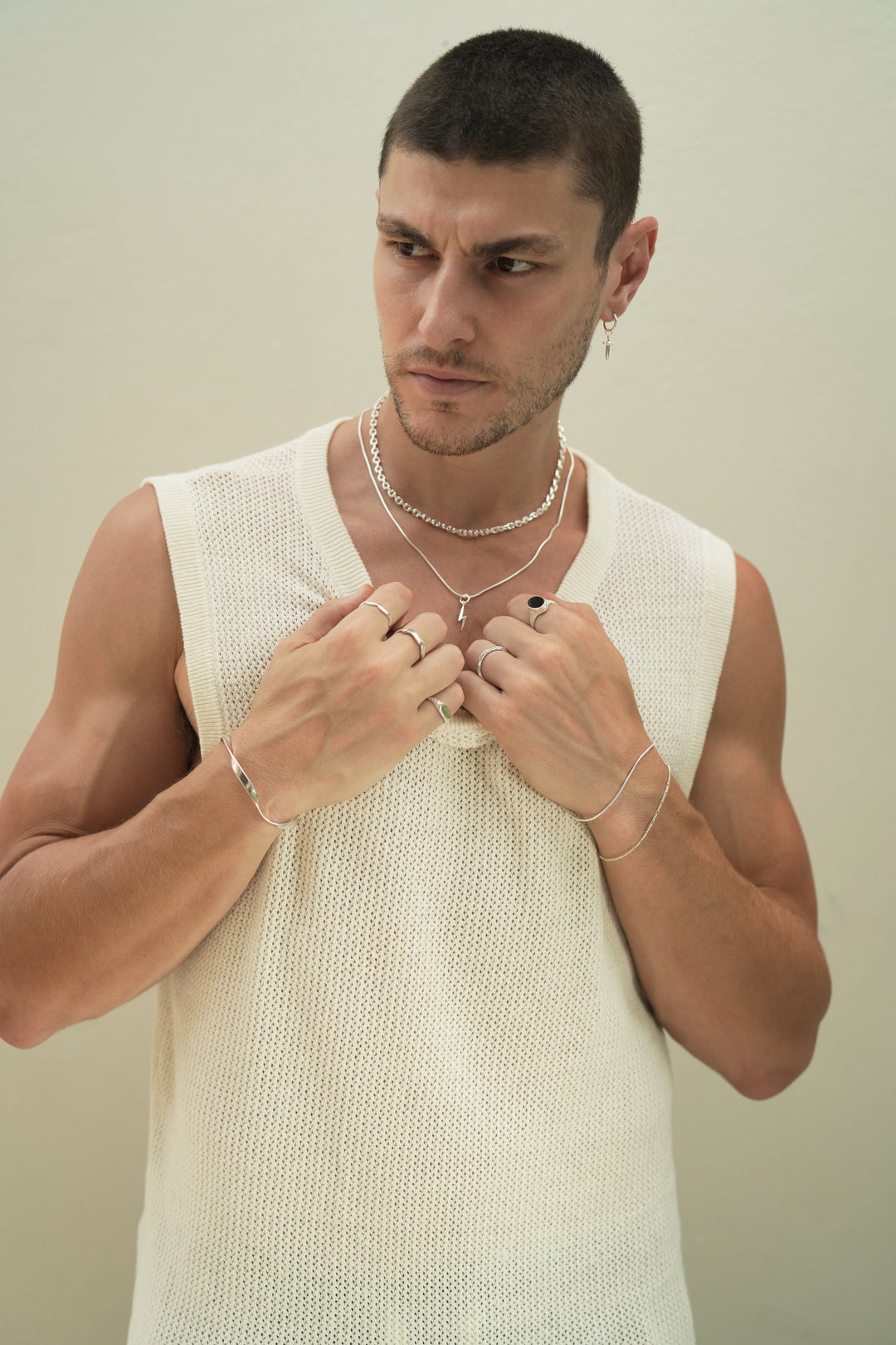 Founder of Nusands Corey Micari wearing a range of Sterling Silver bracelets, cuff, rings and necklaces with a close focus on the lightning bolt charm
