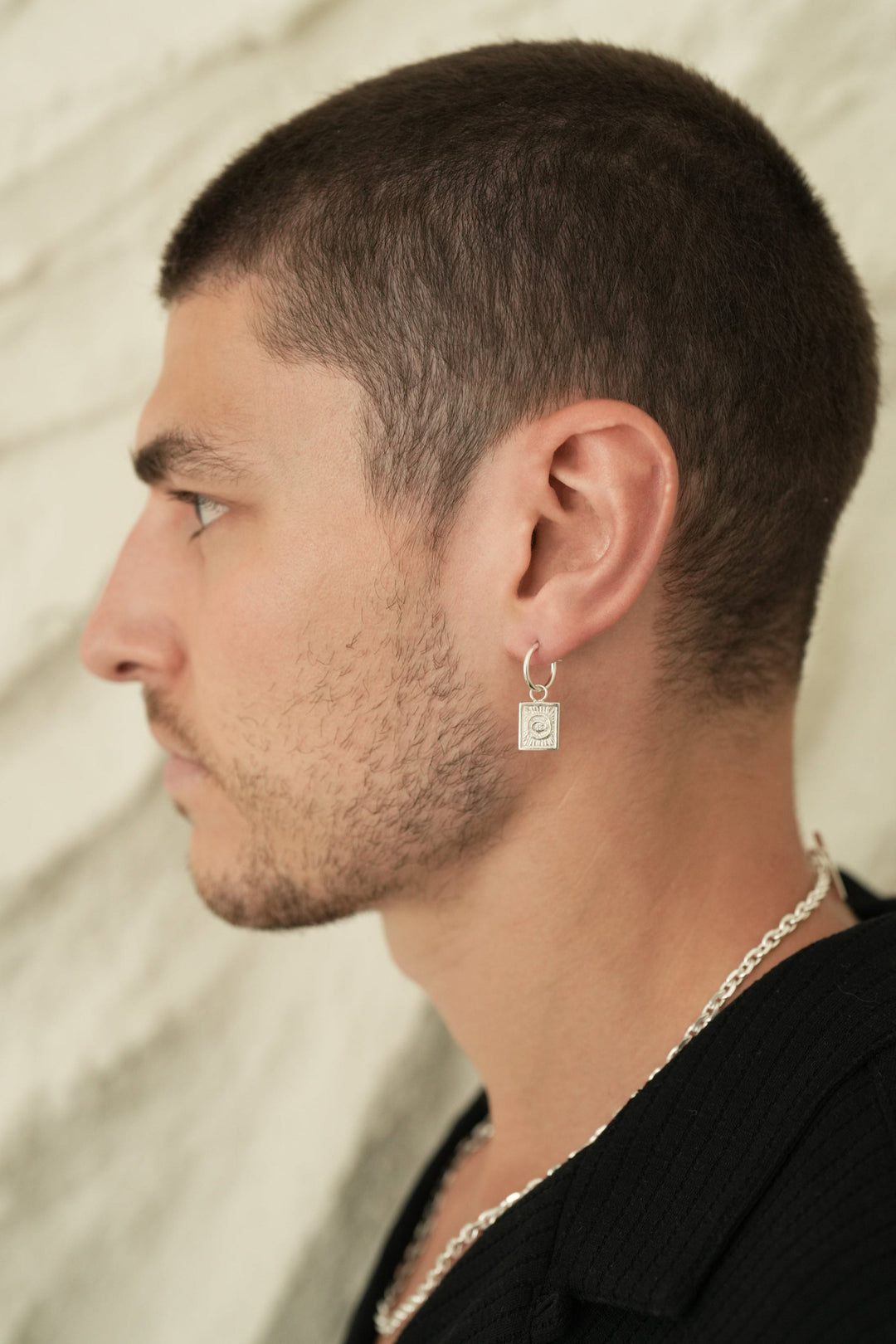 Founder of Nusands Corey Micari side profile wearing the sterling silver evil eye earring