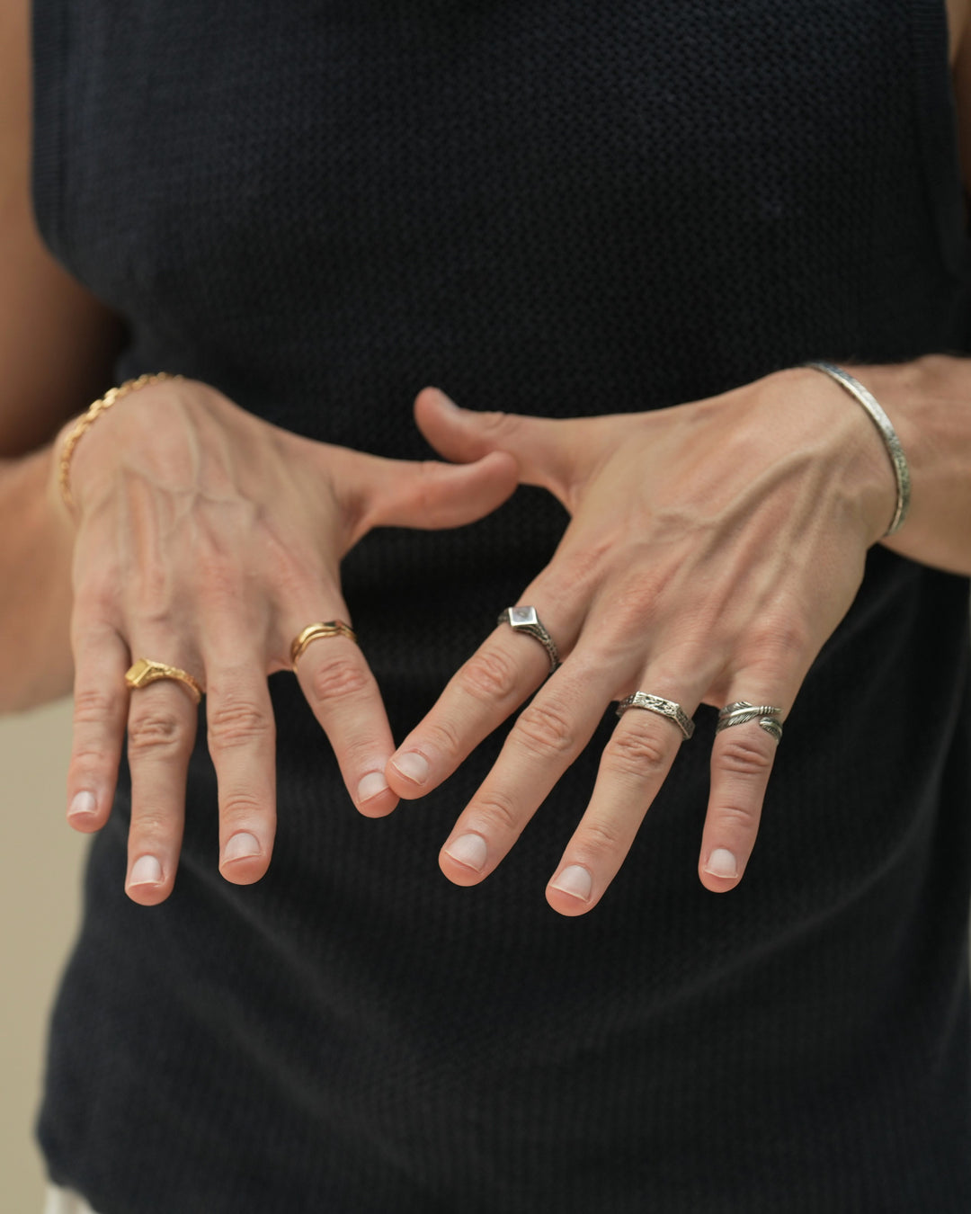 Founder of Nusands Corey Micari wearing 3 sterling silver rings, Blade, Six Base and Suns Out on his left hand, Wave Rings and Suns out in 18K Gold on his right.