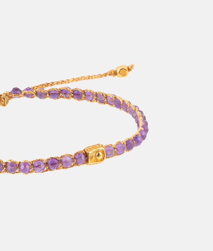 Amethyst Crystal Gemstone Adjustable bracelet strung together with 18K Gold Yarn, close up view.