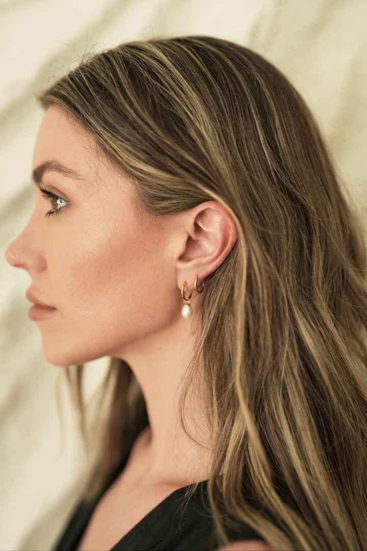 Found of Nusands Emily Micari side head profile wearing 18k Gold pearl hoop earrings