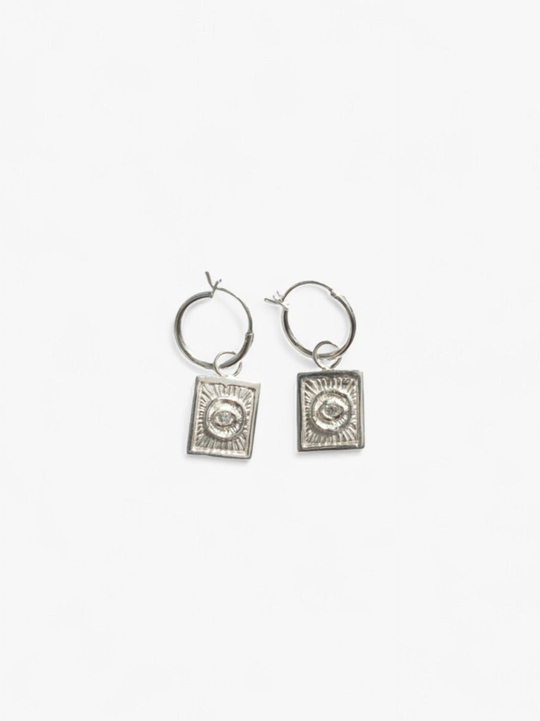 pair of sterling silver hoop earrings with removable evil eye charms