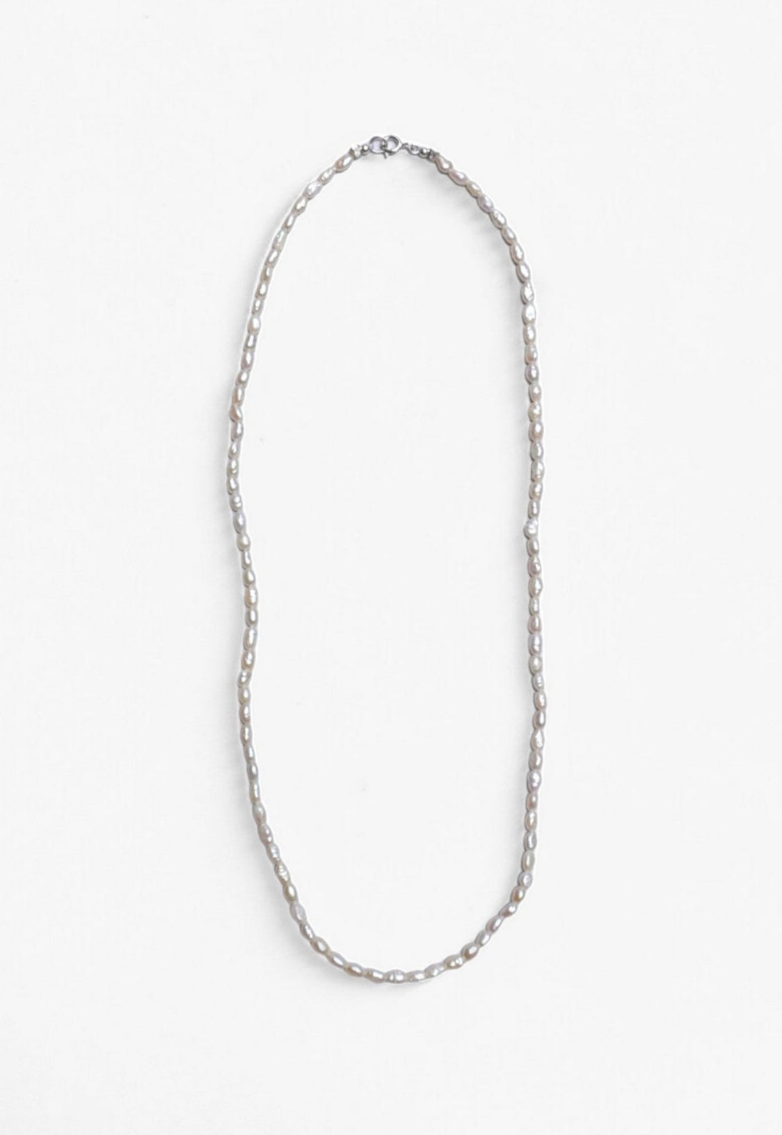 Freshwater Pearl necklace laid flat with Sterling Silver clasp.