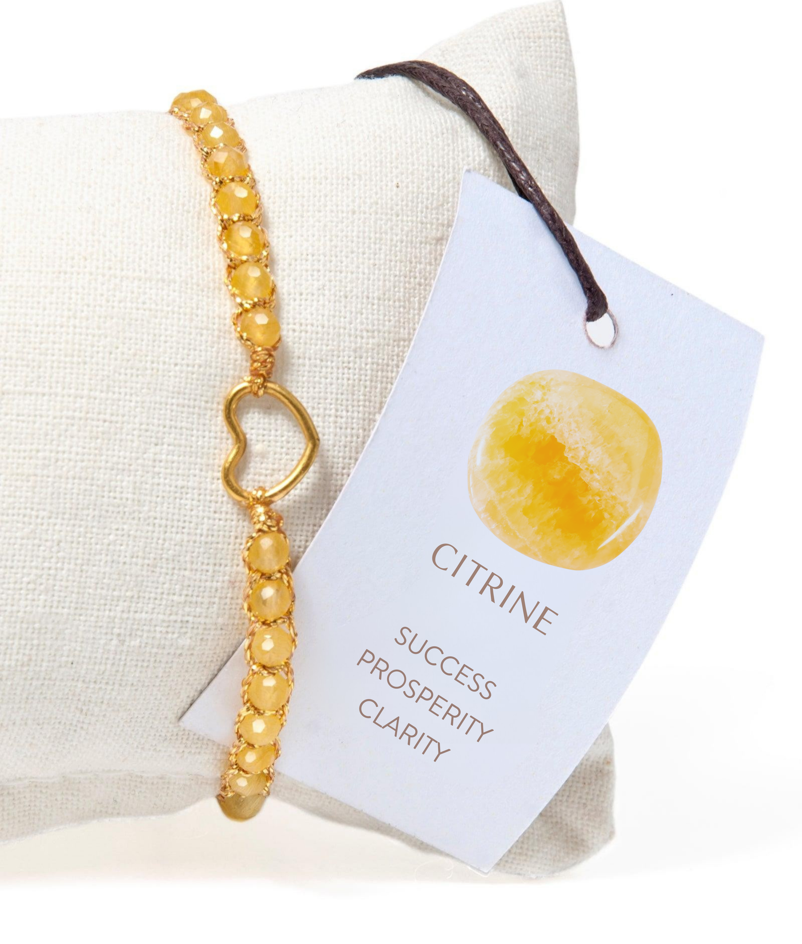 Yellow beaded gemstone bracelet on a white cushion with a card describing its properties.