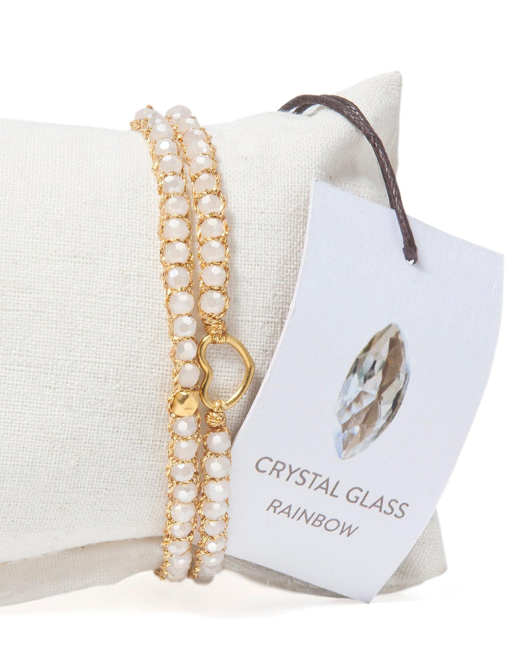 Kids crystal gold bracelet on a white cushion with a label indicating 'Crystal Glass Rainbow'.