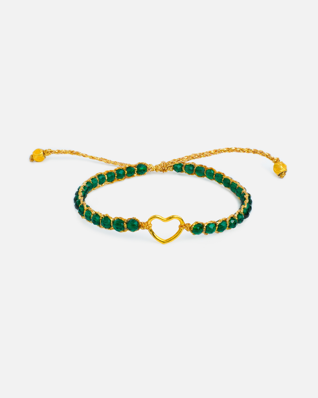 Kids green and gold bracelet with heart charm and green stones on a white background