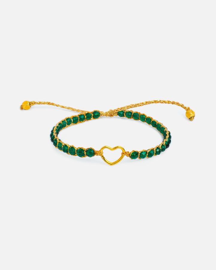 Kids green and gold bracelet with heart charm and green stones on a white background