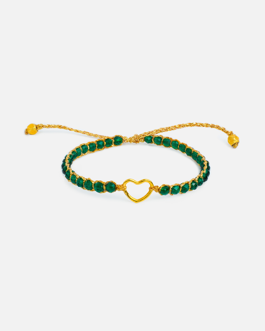 Kids green and gold bracelet with heart charm and green stones on a white background