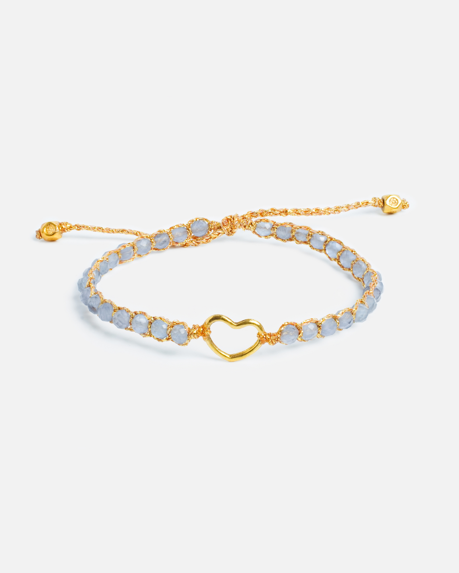 Light purple beaded bracelet with heart clasp and gold yarn on a white background