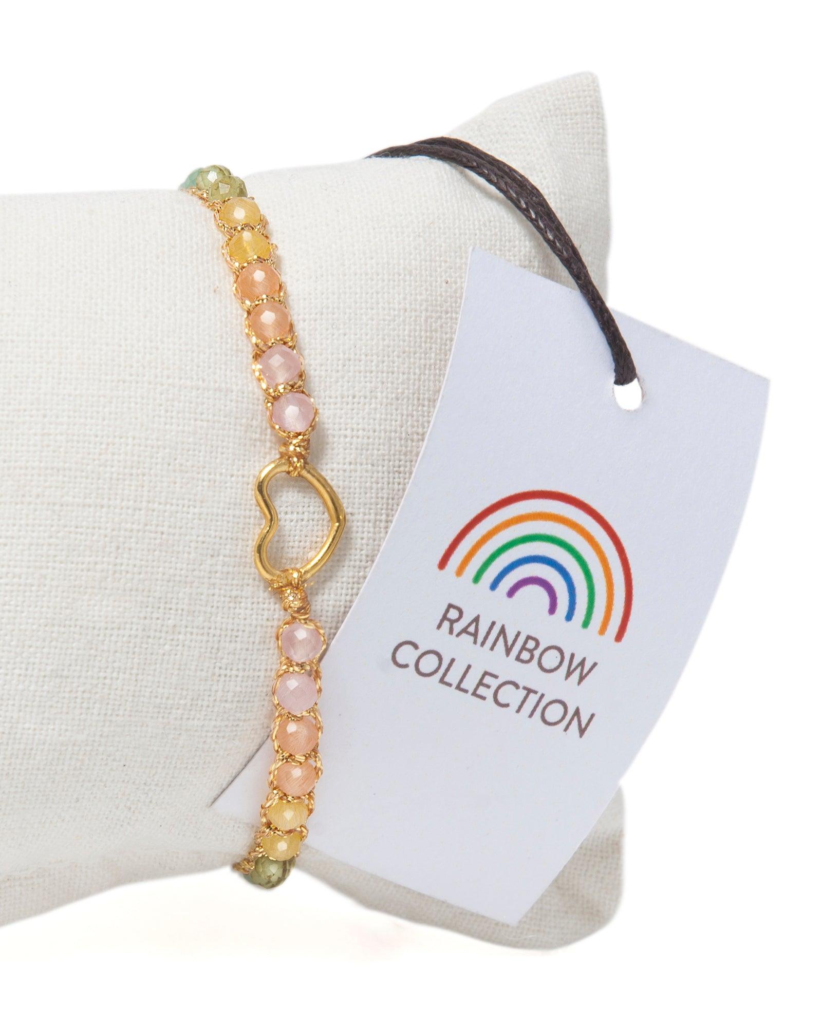 Rainbow beaded gemstone bracelet on a white cushion with a 'Rainbow Collection' hangtag.