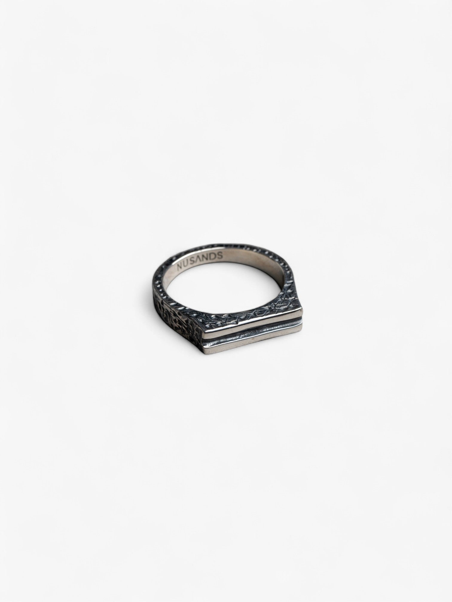 sterling silver line in the sand ring laying flat