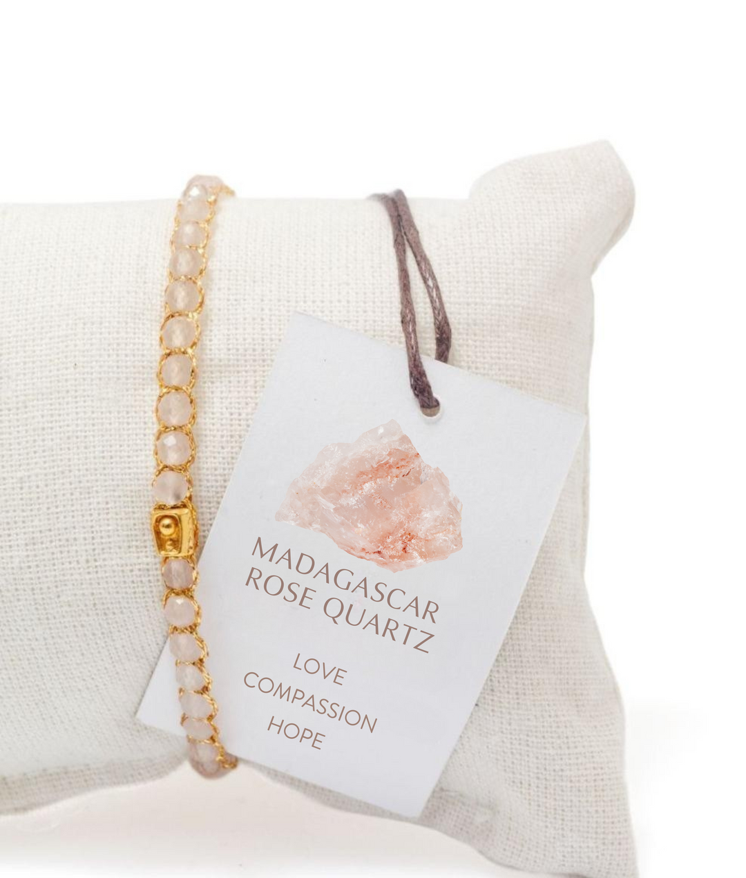 Bracelet with Madagascar Rose Quartz core meanings and properties on a white cushion
