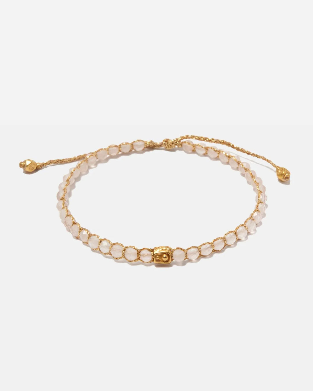 Madagascar Rose Quartz crystal bracelet with adjustable gold yarn clasp on a white background
