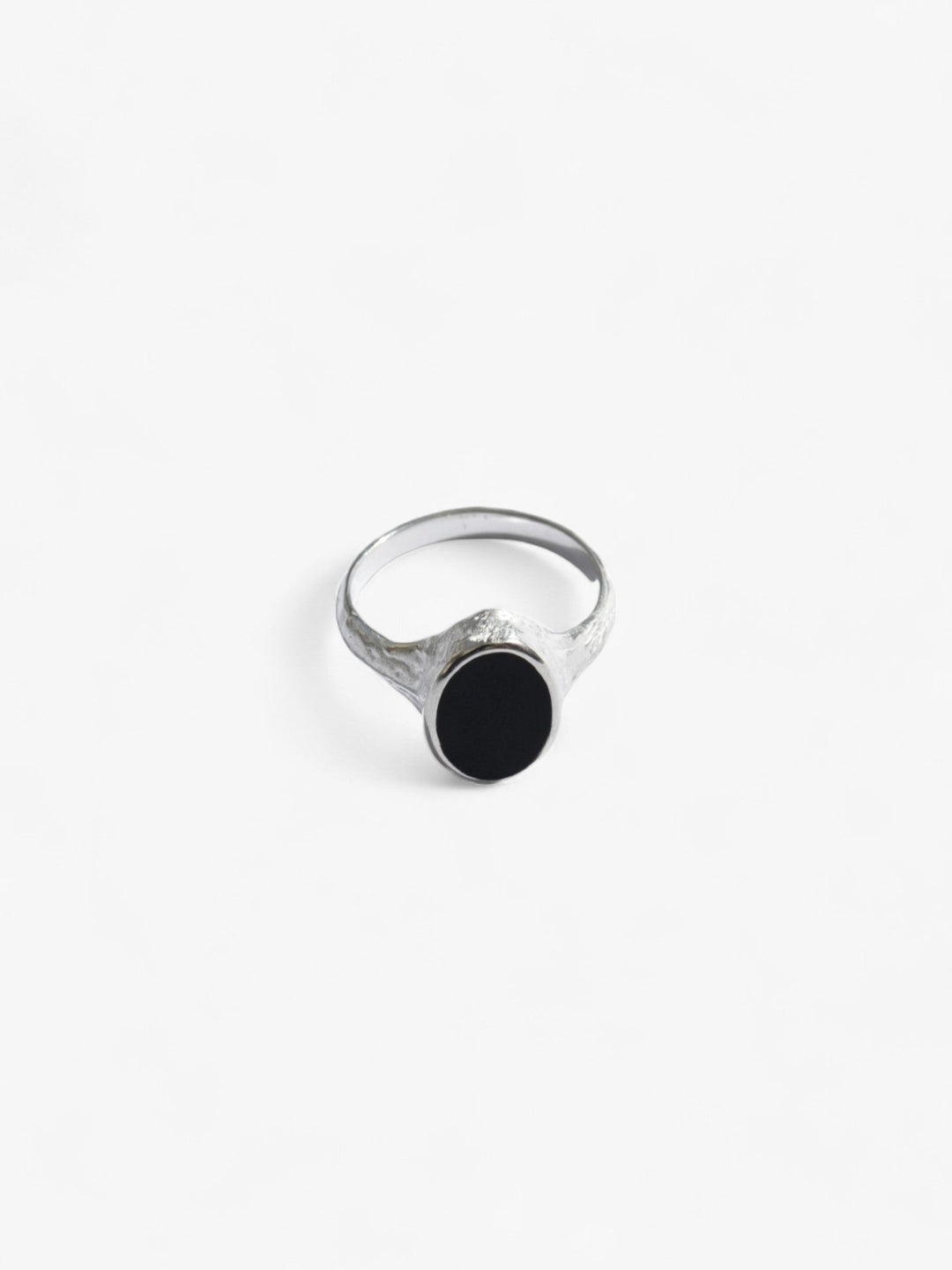 Nusands Midnight Onyx Ring in Sterling Silver laying flat front on view. Oval shaped top with flat black onyx stone as a feature. 