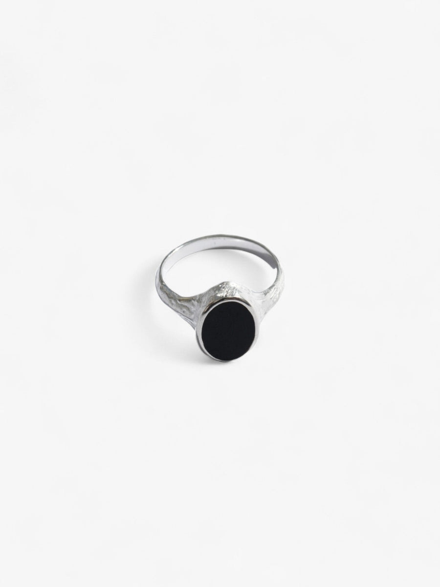 Nusands Midnight Onyx Ring in Sterling Silver laying flat front on view. Oval shaped top with flat black onyx stone as a feature. 