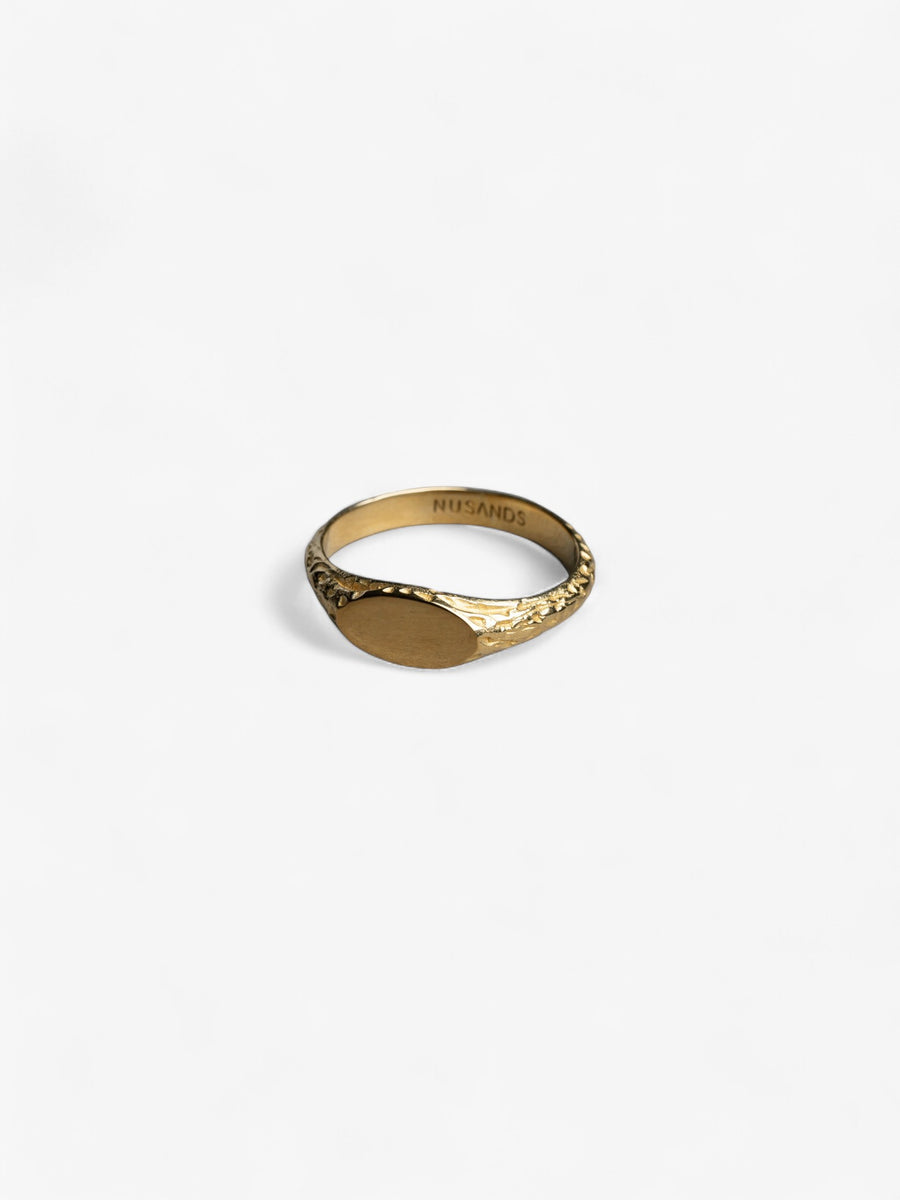 18k gold mirrored signet ring laying flat