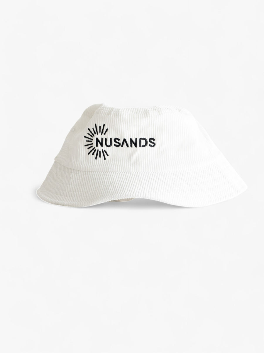 white corduroy bucket hat with black nusands logo on it.