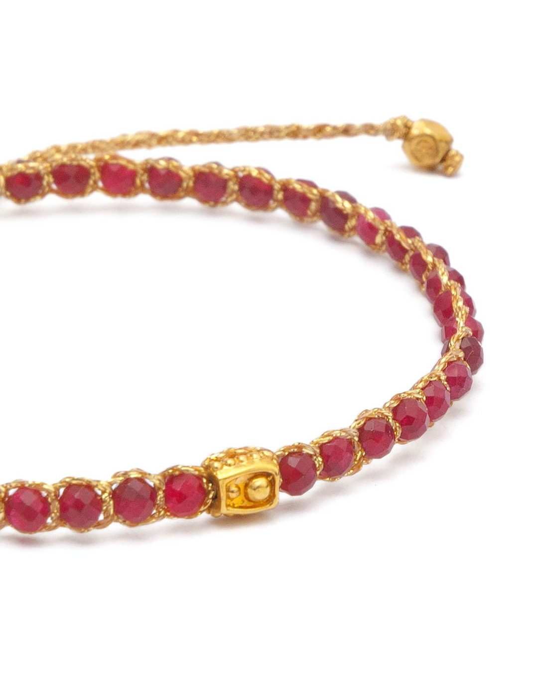 Ruby Red Gemstone Adjustable bracelet strung together with 18K Gold Yarn, close up view.