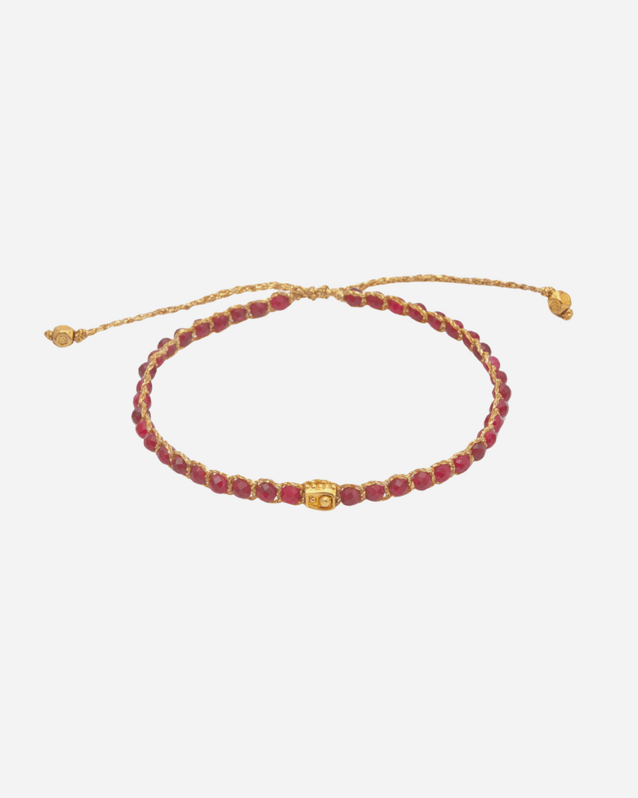 Red Aventurine Crystal Gemstone Bracelet. Adjustable bracelet strung together with red crystal gemstones and 18K Gold Yarn.