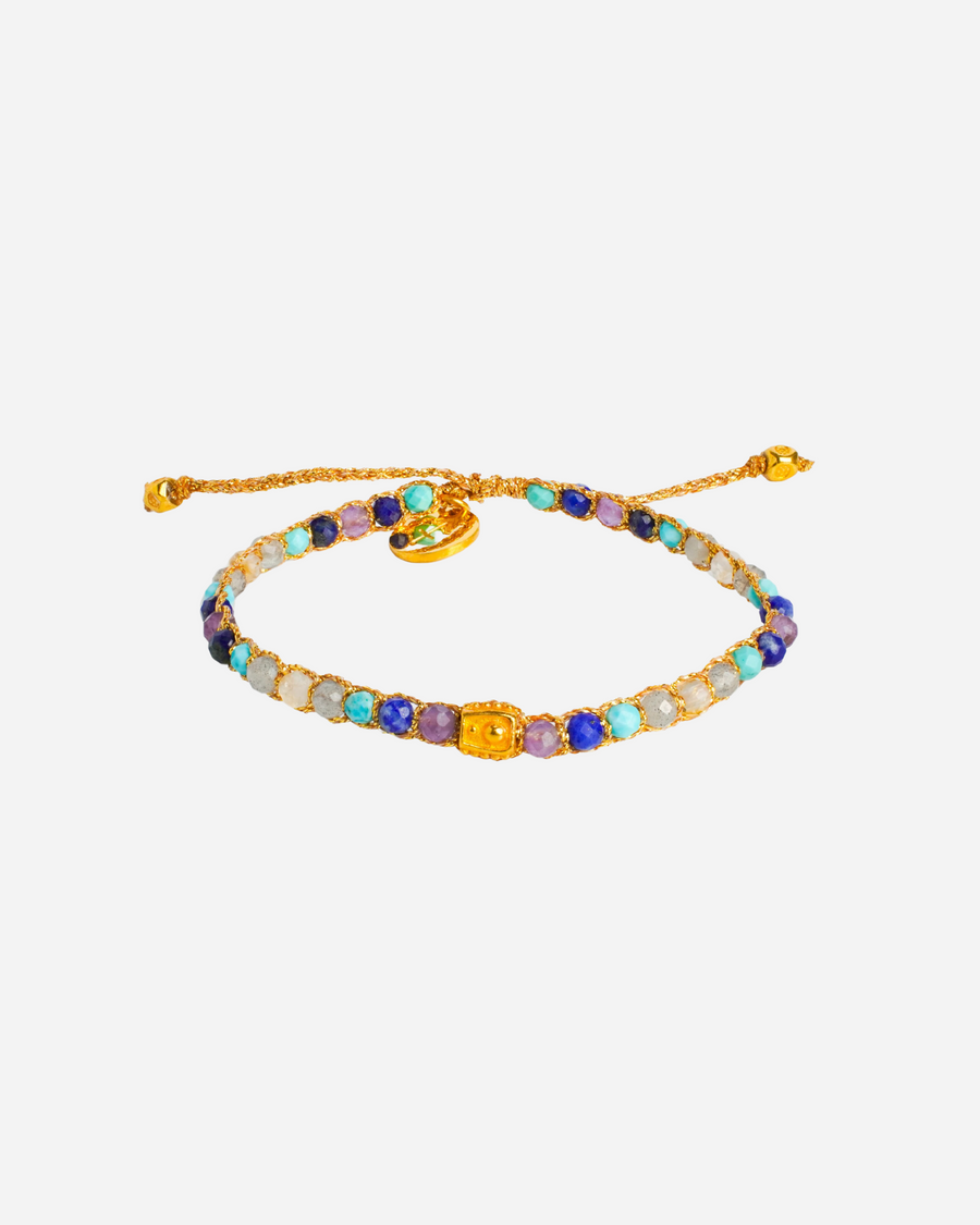 Sagittarius Crystal Zodiac Gemstone Bracelet with different blue, purple, and clear gemstones woven in pure silver yarn and plated with 18k gold.