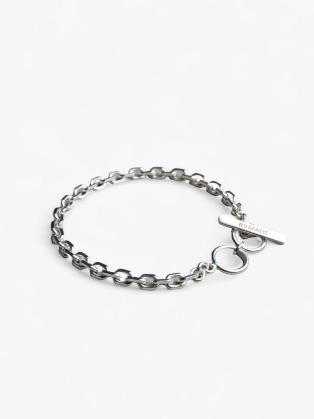 sterling silver shiny link thick chain bracelet with nusands clasp in a round circle.