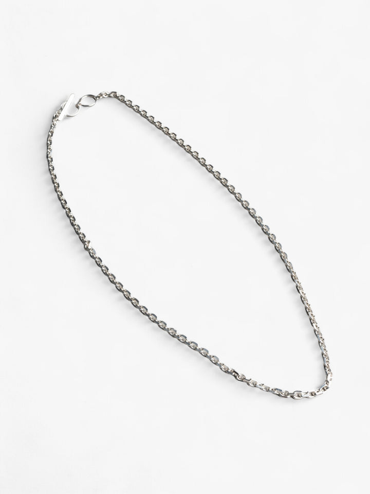 thick sterling silver link chain style necklace with nusands labelled link clasp laying flat