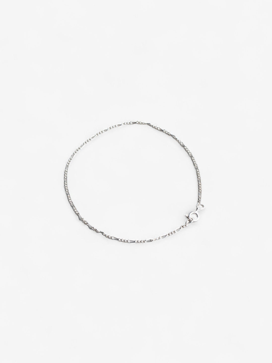 Sterling silver thing daint signature chain bracelet laid flat in a circle