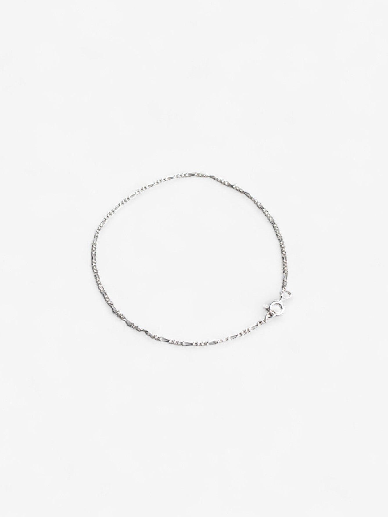 Sterling silver thing daint signature chain bracelet laid flat in a circle