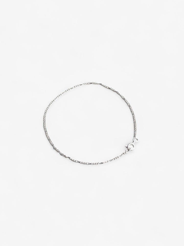 Sterling silver thing daint signature chain bracelet laid flat in a circle