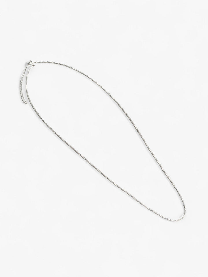 Sterling silver signature chain necklace, thin dainty necklace laid flat.