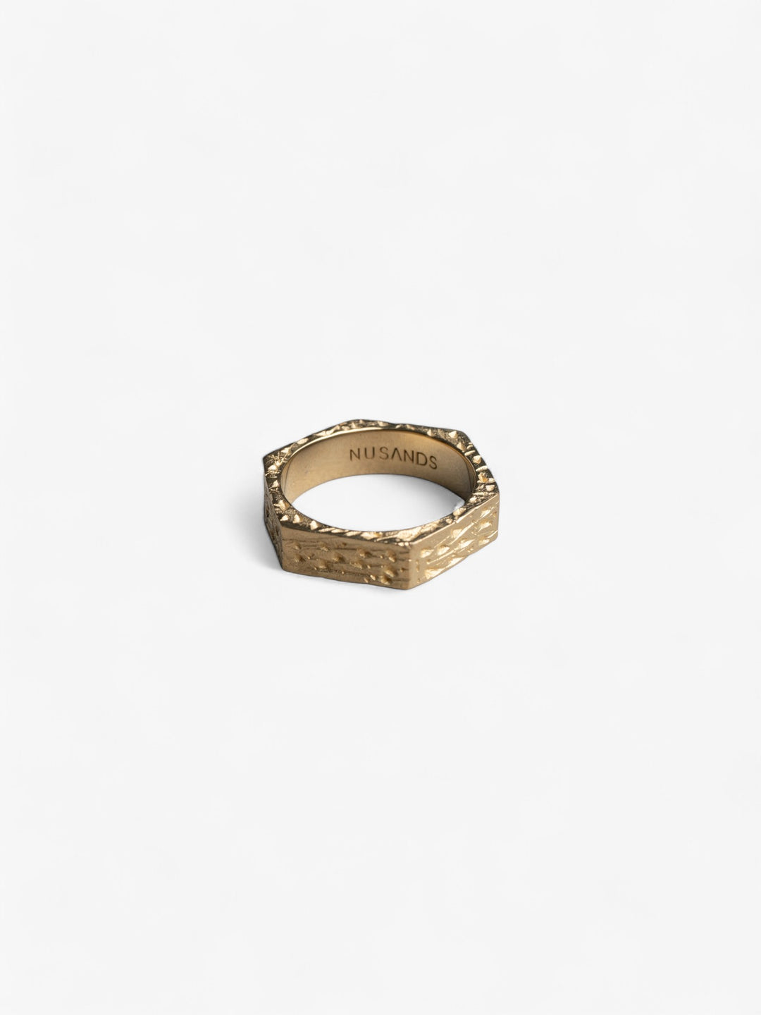 hexagon shaped 18K Gold ring laying flat, hammered finish - nusands six base ring.