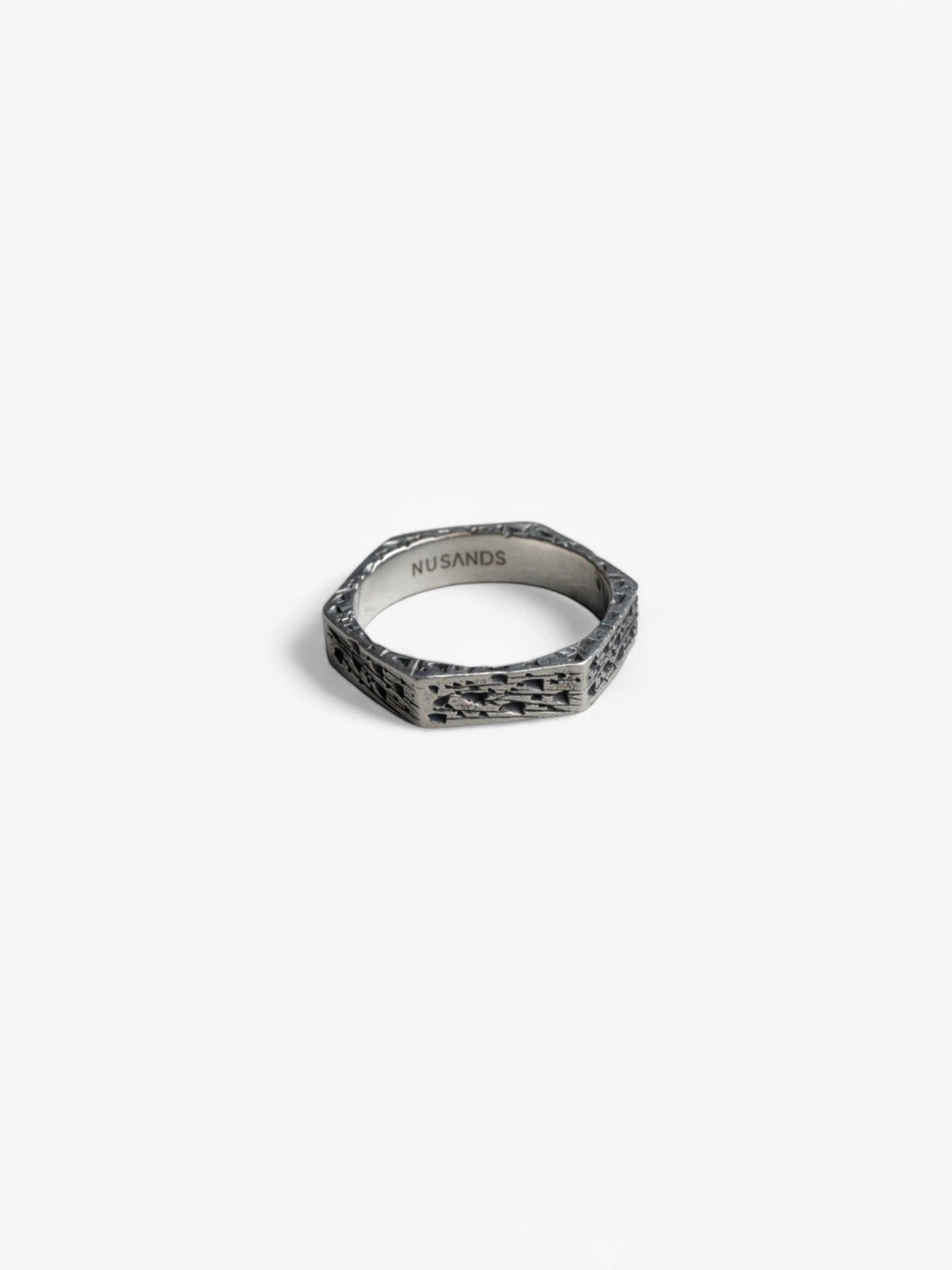 hexagon shaped sterling silver ring laying flat, hammered oxidised finish - nusands six base ring.