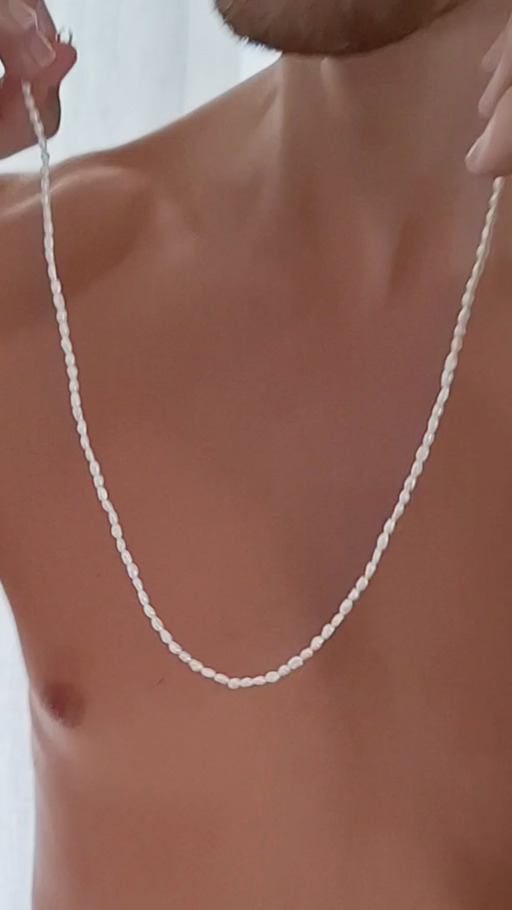 Corey putting on Nusands dainty freshwater Pearl Necklace with Sterling Silver clasp.